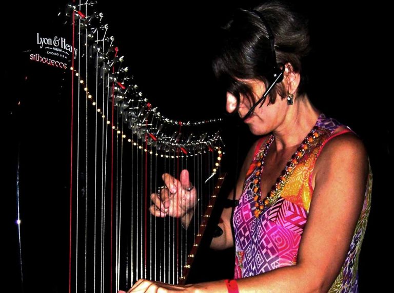 Red Reyne musician playing Harp