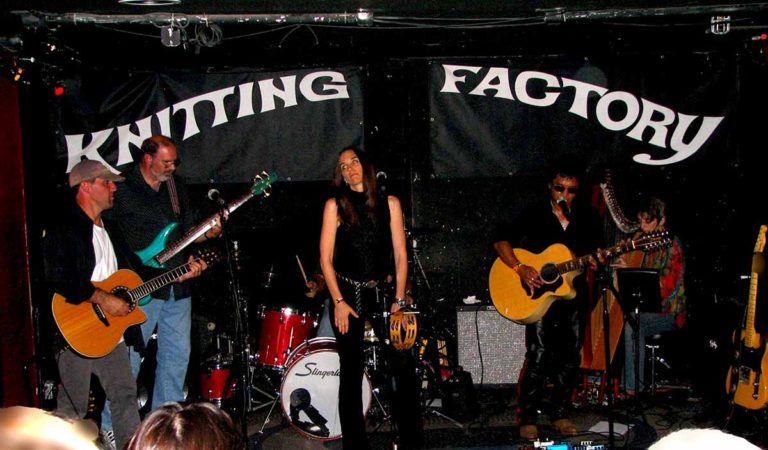 Red Reyne performing on stage with band members at Knitting Factory